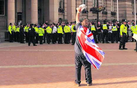 An English Defence League (EDL) supporter taunts police. Image: Birmingham Mail